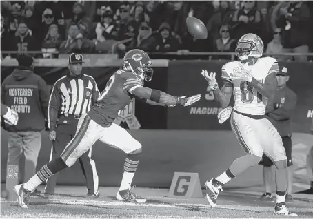  ?? Charles Rex Arbogast/Associated Press photos ?? Lions receiver Calvin Johnson scores a touchdown against Bears cornerback Charles Tillman in the second half Sunday in Chicago.