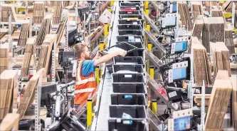  ?? GIULIO NAPOLITANO BLOOMBERG ?? CBRE estimates that a $1 increase in average wages for a typical warehouse would raise annual costs by more than $1 million.