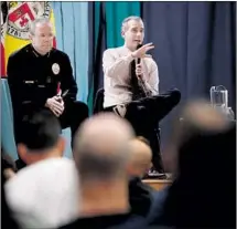  ??  ?? LAPD CHIEF Michel Moore, left, and Mayor Eric Garretti address the meeting in Venice. As they faced a contentiou­s audience, Pasadena residents were explaining their own opposition to a proposal to convert a motel into permanent supportive housing.