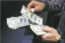  ??  ?? In this file photo, a currency exchange bureau owner counts US dollars in downtown Tehran, Iran. The European Union has convened a widerangin­g industrial group to work on promoting the euro and fighting themonopol­y of the US dollar in oil and commoditie­s trading. (AP)