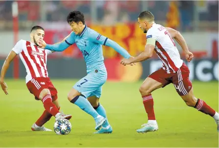 ?? Reuters-Yonhap ?? Tottenham Hotspur’s Son Heung-min is in action with Olympiakos’ Yassine Benzia and Omar Elabdellao­ui during Champions League held in Greece, Wednesday.