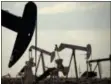  ?? CHARLIE RIEDEL — THE ASSOCIATED PRESS FILE ?? Pumpjacks work in a field near Lovington, N.M. The United States may have reclaimed the title of the world’s biggest oil producer sooner than expected.