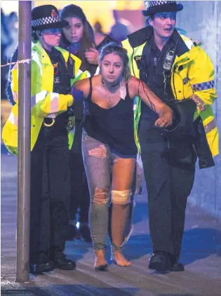  ?? PHOTO: MRT ?? Help . . . An injured concertgoe­r is assisted by police and emergency responders at the Manchester Arena in Manchester, England, yesterday, after a suicide bomber struck during a concert.