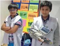  ??  ?? Aadi and Aarush Veoma explain how their ‘MachineKra­ft’ works during the World Robot Olympiad in Abu Dhabi on Tuesday.