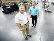  ?? JOE BURBANK/ORLANDO SENTINEL ?? Orange County Comptrolle­r Phil Diamond, left, and surplus county property manager Bryan LeFils survey items available for a recent virtual auction.