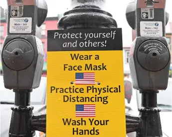  ?? SUSAN WALSH/ AP ?? Parking meters in downtown Annapolis, Maryland, on Friday encourage hand washing, mask wearing and social distancing.