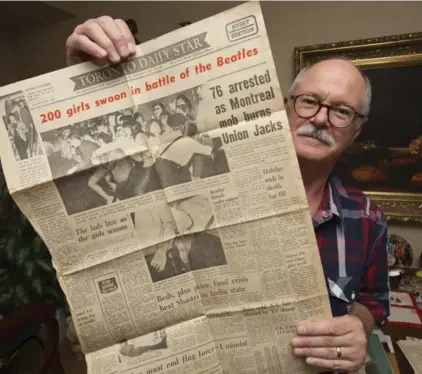  ?? BERNARD WEIL/TORONTO STAR ?? Ron Demers holds a copy of the Toronto Daily Star when the Beatles arrived. Demers went to all three Beatles concerted in Toronto.