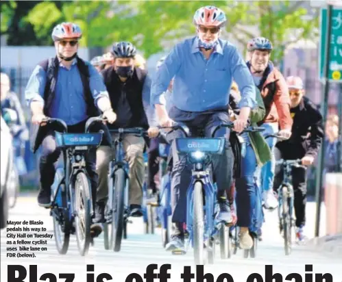  ??  ?? Mayor de Blasio pedals his way to City Hall on Tuesday as a fellow cyclist uses bike lane on FDR (below).