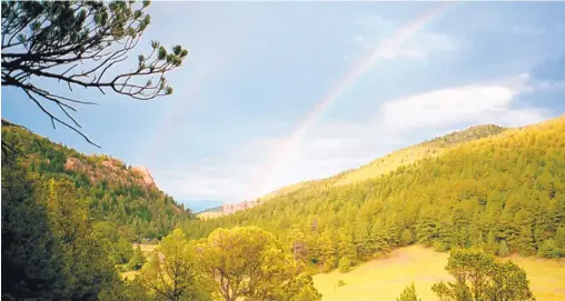  ?? ASSOCIATED PRESS ?? A double rainbow is seen in the early evening on the 140,000-acre Philmont Scout Ranch near Cimarron.