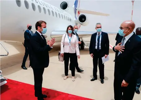  ?? AP ?? French President Emmanuel Macron being welcomed on Tuesday by Mauritania’s President Mohamed Ould Ghazouani at Nouakchott airport.