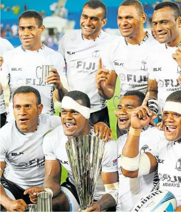  ?? GETTY IMAGES ?? ALL SMILES: Fiji players celebrate winning the 2014 Gold Coast Sevens.