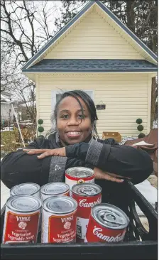  ??  ?? LaMarr-Murphy pauses outside what she calls her she-shed, where she stores equipment for the food pantry.