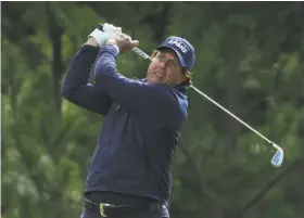  ?? Jeff Gross / Getty Images ?? Phil Mickelson eyes his shot on the 18th hole of Thursday’s opening round at the Monterey Peninsula’s Shore Course. He hit all 13 fairways on the course.