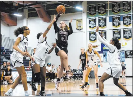  ?? Bizuayehu Tesfaye Las Vegas Review-journal @btesfaye ?? Faith Lutheran junior Raina Forgue splits the Shadow Ridge defense on her way to the basket for two of her team-high 18 points in the Crusaders’ 80-48 road victory Wednesday.