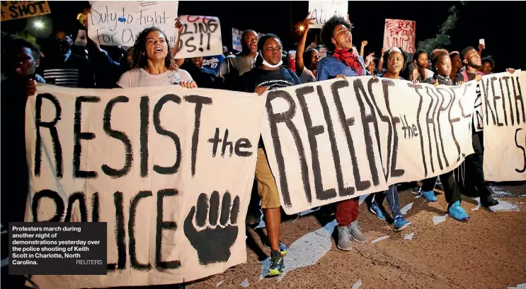  ??  ?? Protesters march during another night of demonstrat­ions yesterday over the police shooting of Keith Scott in Charlotte, North Carolina.