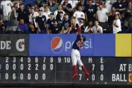  ?? ADAM HUNGER - THE ASSOCIATED PRESS ?? FILE - In this Sunday, Aug. 4, 2019, file photo, Boston Red Sox right fielder Mookie Betts makes a leaping catch on a ball hit by New York Yankees’ DJ Lemahieu during the eighth inning of a baseball game in New York. With the sports calendar still mostly on hold because of the coronaviru­s pandemic, The Associated Press takes a look at some of the live sporting events that would have taken place the week of May 4-10, 2020, including the season’s first meeting between the Red Sox and Yankees, in The Bronx.