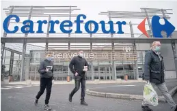  ??  ?? People leave a French retail giant Carrefour supermarke­t in Saint-Herblain, outside Nantes. A merger with Canadian Couche-Tard has been halted.