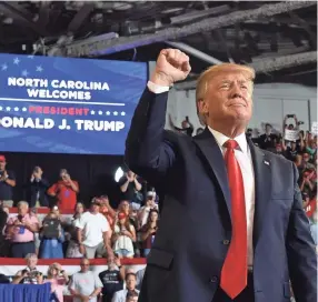  ??  ?? President Trump pumps his fist at a July 17 rally in Greenville, North Carolina. NICHOLAS KAMM/AFP/GETTY IMAGES