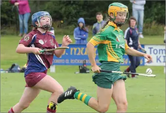  ??  ?? Katie Murphy of Rathgarogu­e-Cushinstow­n on a solo run with Bunclody’s Aoife Murphy in pursuit during their recen t Under-14 camogie championsh­ip final meeting in Oylegate.