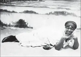  ?? Photograph­s from UC San Diego ?? A PORTRAIT of a Black woman on the beach is one of hundreds of photos and other materials from the mid-1800s to the early 1900s in the Turner Collection.