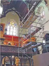  ??  ?? Scaffoldin­g used to help disassembl­e the organ stands in the sanctuary of St Mary’s Church in Newport, RI.