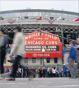  ?? Nam Y. Huh Associated Press ?? FANS ARRIVE at Wrigley Field before Game 1 of the National League Championsh­ip Series between the Chicago Cubs and the Los Angeles Dodgers.