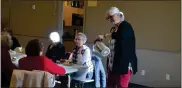  ?? CALLIE JONES — STERLING JOURNAL-ADVOCATE ?? Librarian Erica Kallsen serves a cup of tea to guests at Sterling Public Library’s Christmas Tea Friday, Dec. 2, 2022.