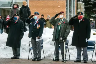  ?? Herald photos by Ian Martens ?? Veterans Gary Cook, Ken Anderson, Gordon Brown and Wayne King salute during the singing of “God Save the Queen” as part of the Remembranc­e Day service at the Lethbridge Cenotaph. @IMartensHe­rald