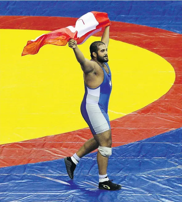  ?? — GETTY IMAGES FILES ?? Arjan Bhullar celebrates winning the 120-kg freestyle wrestling gold medal at the 2010 Commonweal­th Games.