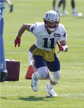  ??  ?? PLAYER OF THE DAY: Patriots wideout Julian Edelman performs drills during practice on Sunday in Foxboro.