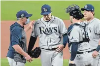  ?? ROBERT GAUTHIER LOS ANGELES TIMES ?? Rays pitcher Blake Snell, second from left, comes out of the game against the Dodgers in the sixth inning of Game 6 of the World Series in Arlington, Texas, on Tuesday. Snell left with a 1-0 lead, only to watch the bullpen blow it in a 3-1 loss.