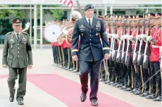  ?? — Reuters ?? The chief commander of the US Army Pacific, General Robert B Brown reviews the honour guard with his Thai counterpar­t, General Chalermcha­i Sitthisart during his visit to Thailand at the Royal Thai Army headquarte­rs in Bangkok on Monday.