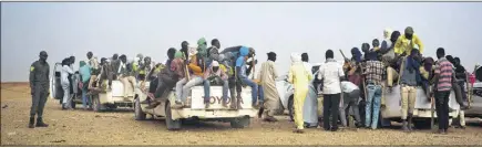  ?? AP PHOTO ?? Nigeriens and third-country migrants head toward Libya from Agadez, Niger, on Monday. Migrants from across subSaharan African, Mali, the Gambia, Guinea, Ivory Coast, Niger and more are part of the mass migration toward Europe, some  eeing violence,...