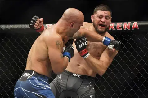  ?? (AP Photo/John Locher) ?? Robbie Lawler, left, throws a punch against Nick Diaz during a middleweig­ht mixed martial arts bout at UFC 266, Saturday, Sept. 25, 2021, in Las Vegas.