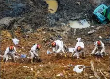  ?? ?? Members of the rescue team search the crash site for the black boxes from flight MU5735 and pieces of aircraft wreckage and debris.