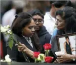  ?? MARK LENNIHAN — ASSOCIATED PRESS ?? A woman leaves flowers at the North Pool during a ceremony marking the 17th anniversar­y of the terrorist attacks on Tuesday in New York.