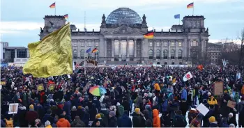  ?? — AFP photo ?? Participan­ts gather during a demonstrat­ion against racism and far right politics in front of the Reichstag building in Berlin, Germany.