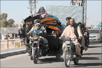  ?? GETTY-AFP ?? People flee Monday from Afghanista­n’s Helmand province amid clashes between Taliban fighters and Afghan security forces. Violence across the country has ticked up recently.