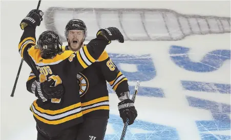  ?? STAFF PHOTO BY MATT STONE ?? DEFENSE DOESN’T REST: Kevan Miller celebrates with Bruins blueliner Torey Krug, whose tally kicked off the Bruins’ four-goal third period rally in last night’s 7-4 victory against the Maple Leafs in Game 7 at the Garden.