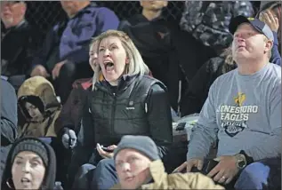  ??  ?? TRINITY SANDERS, center, roots for her sons, Keith and Kaleb Sanders of Jonesboro High, whose coach, Eddie Gallegos, said his players are tough and “they know how to get after it.”