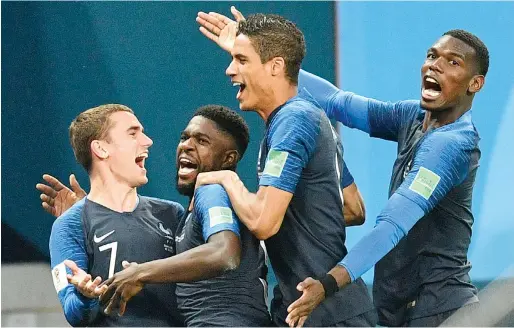  ?? AP ?? France’s Samuel Umtiti (second left) is congratula­ted by Griezmann, Varane and Pogba after scoring a goal during the semifinal match against Belgium. —