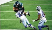  ?? ROGER STEINMAN / AP 2020 ?? According to NFL Network’s Mike Garafolo, the Bengals agreed to terms Tuesday on a three-year deal with former Dallas Cowboys cornerback Chidobe Awuzie (24), shown here tackling the Eagles’ Zach Ertz.