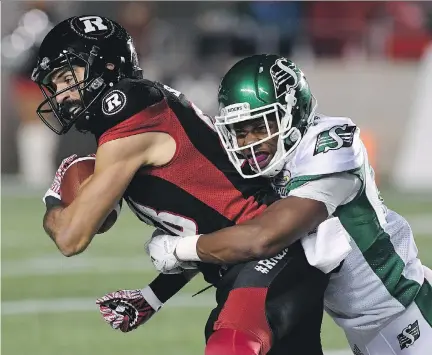  ?? JUSTIN TANG/THE CANADIAN PRESS ?? Ottawa Redblacks wide receiver Brad Sinopoli, left, keeps the ball away from Saskatchew­an Roughrider­s defensive back Otha Foster III, right, during the first half of Friday’s game in Ottawa. The Redblacks gave up a 17-point lead in the 18-17 loss.