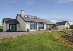  ??  ?? Clockwise from left: Ard na Mara in Glengarrif­f, Co Cork was redesigned and renovated by the current owners; the kitchen/ dining area has a central island; the upstairs den; the entrance hall; one of three downstairs bedrooms, and sunset over Bantry Bay