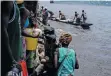  ?? ?? STREET vendors moor on a whaleboat to sell goods to people making the 520km journey