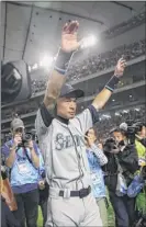  ?? Toru Takahashi / Associated Press ?? Seattle’s Ichiro Suzuki waves to fans after returning to the field after the Mariners’ victory over Oakland in Japan. It was Suzuki’s last game.