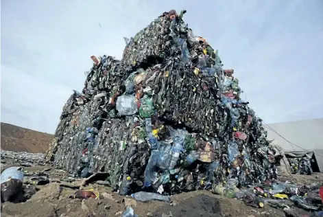  ?? THE ASSOCIATED PRESS FILES ?? Plastic trash is compacted into bales ready for further processing at the waste processing dump on the outskirts of Minsk, Belarus. A new massive study finds that production of plastic and the hard-to-breakdown synthetic waste is soaring in huge...