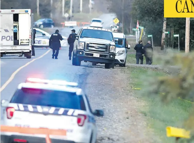  ?? JUSTIN TANG / THE CANADIAN PRESS ?? Police investigat­e the site of a small plane crash in the Carp area of Ottawa after two planes collided in mid-air on Sunday morning.