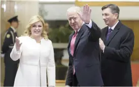  ?? — AP ?? ZAGREB: US Vice President Joe Biden, center, Croatia’s President Kolinda Grabar-Kitarovic, left and Slovenia’s President Borut Pahor greet the media in Zagreb yesterday.