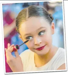  ??  ?? Isabella de Carlo, 11, from Theatre and Dance, Brisbane, adds the final touches before performing yesterday.